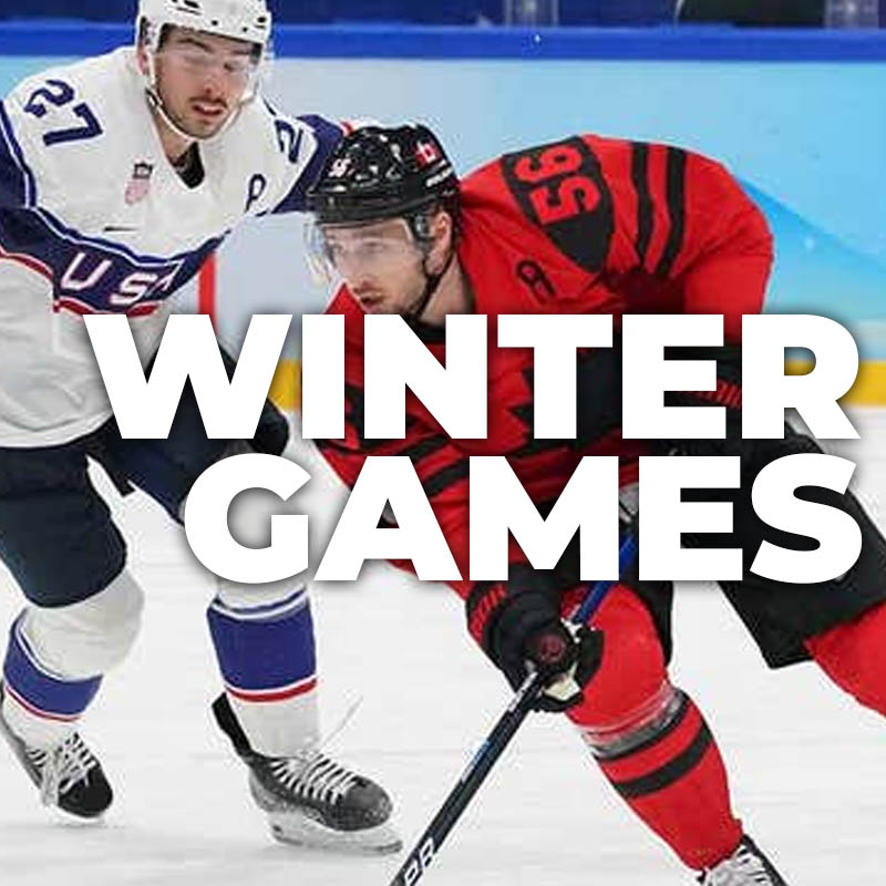 Winter Games host city at night with mountains in the background